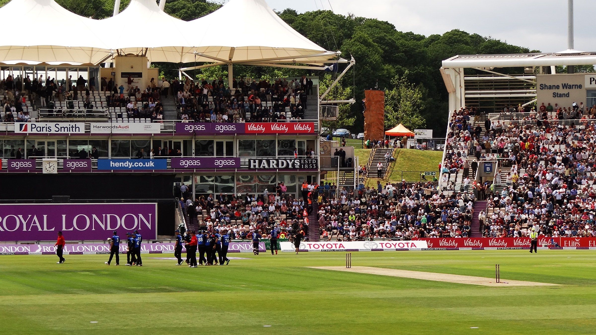 A big crowd fills the pavilion and the Shane Warne Stand at the Utilita Bowl in Southampton during a one-day international, with players walking off the outfield