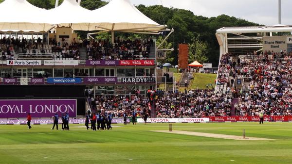 A big crowd fills the pavilion and the Shane Warne Stand at the Utilita Bowl in Southampton during a one-day international, with players walking off the outfield