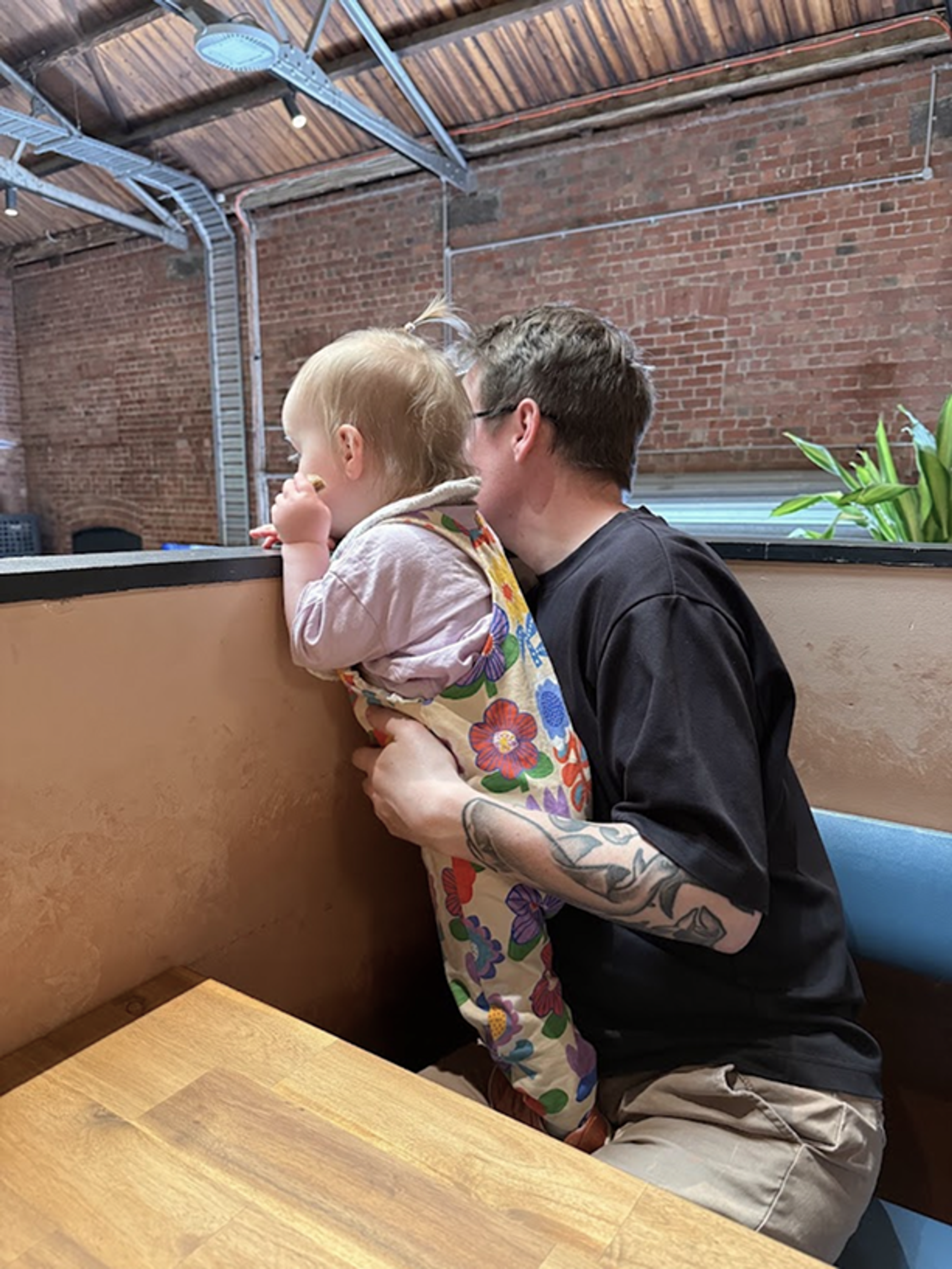 Dave & Lottie looking over a ledge at a bar