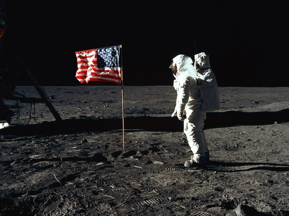 Buzz Aldrin standing beside the United States flag on the Moon during Apollo 11