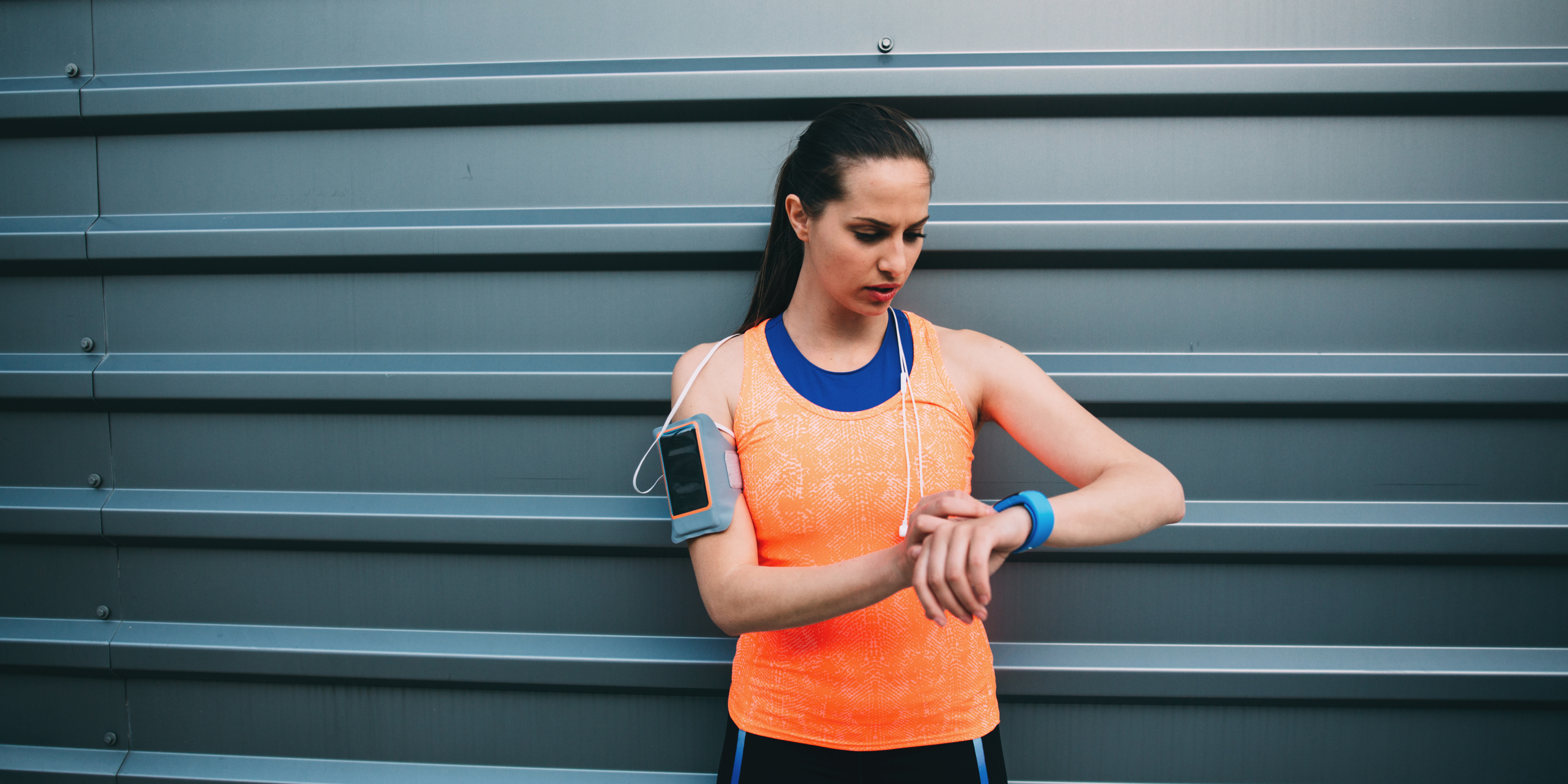 Female runner tracking her training to prevent overuse injuries.