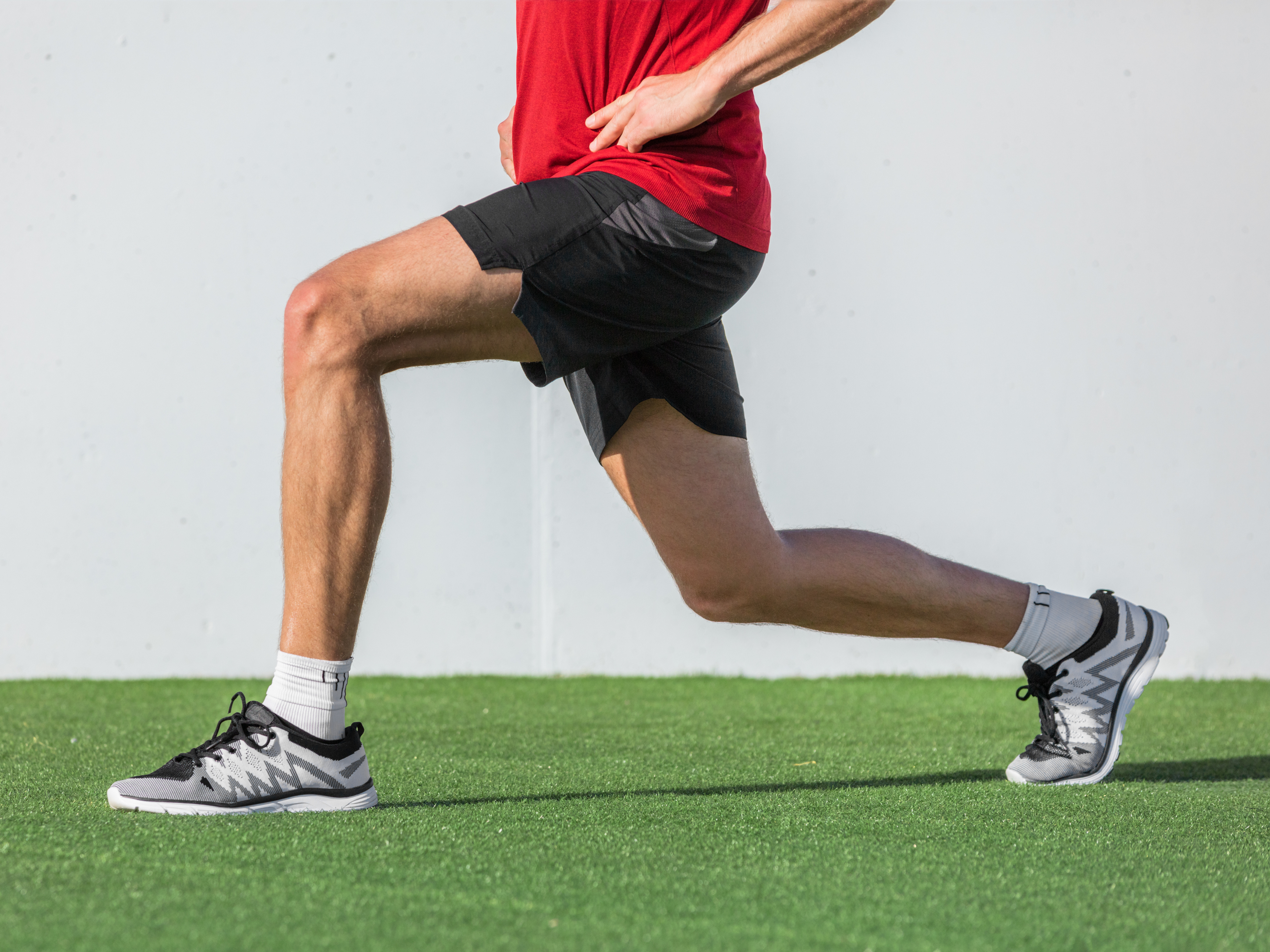 Man performing the forward lunge exercise.
