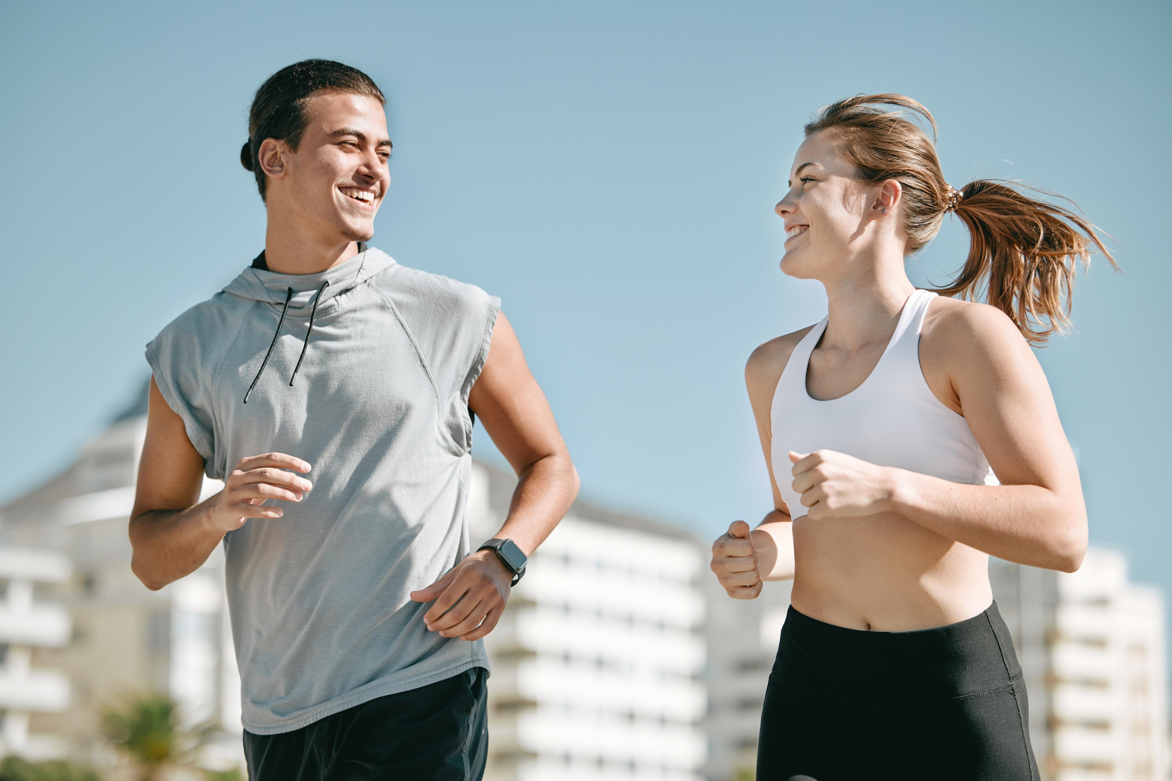 Two runners jogging and discussing how happy they are to be getting back to running after injury.