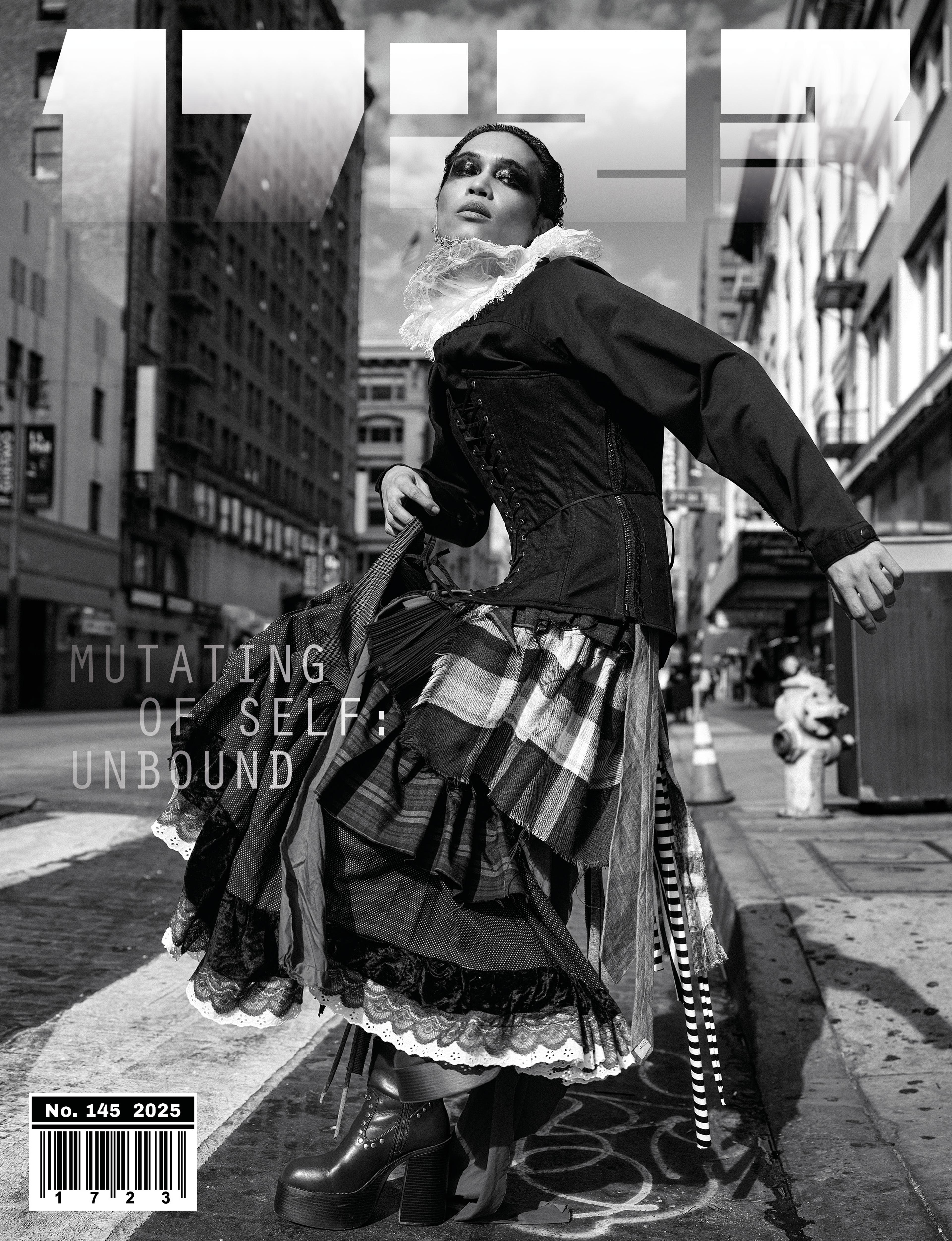 Black and white magazine cover of model wearing skirts walking in the street facing the camera.