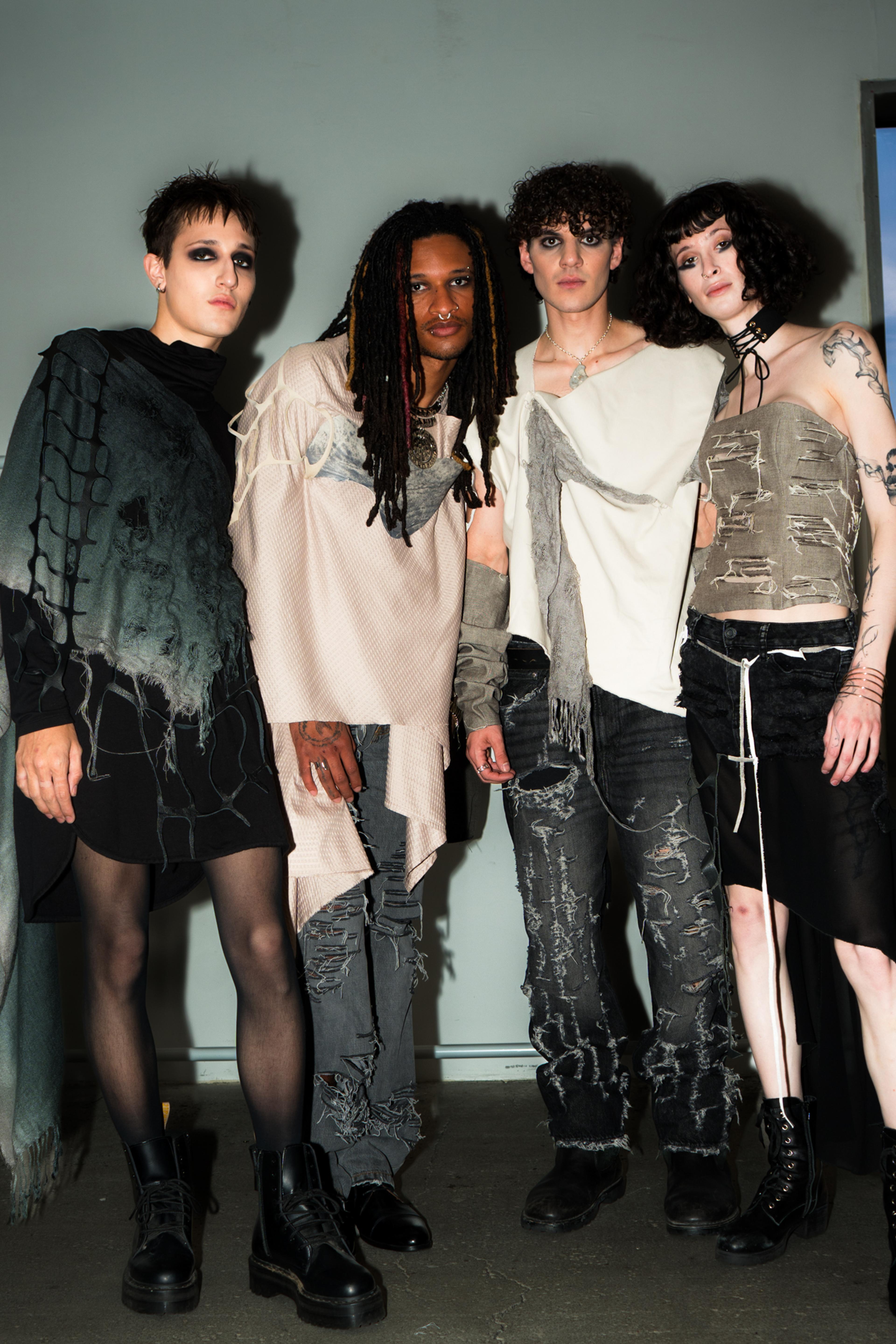 Models wearing distressed clothing in nude tones facing the camera.