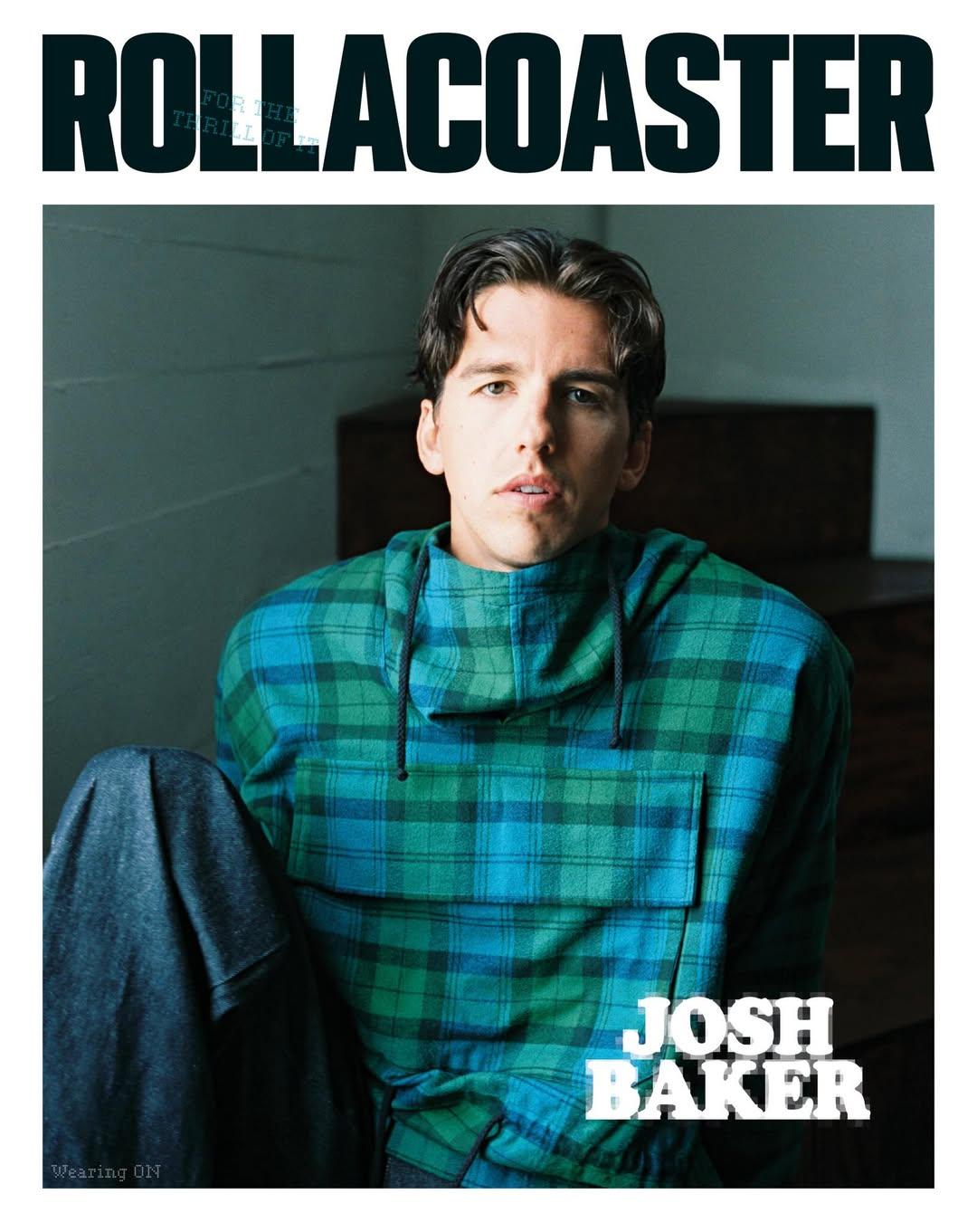 Josh Baker wearing green and blue plaid hoodie sitting down facing the camera.