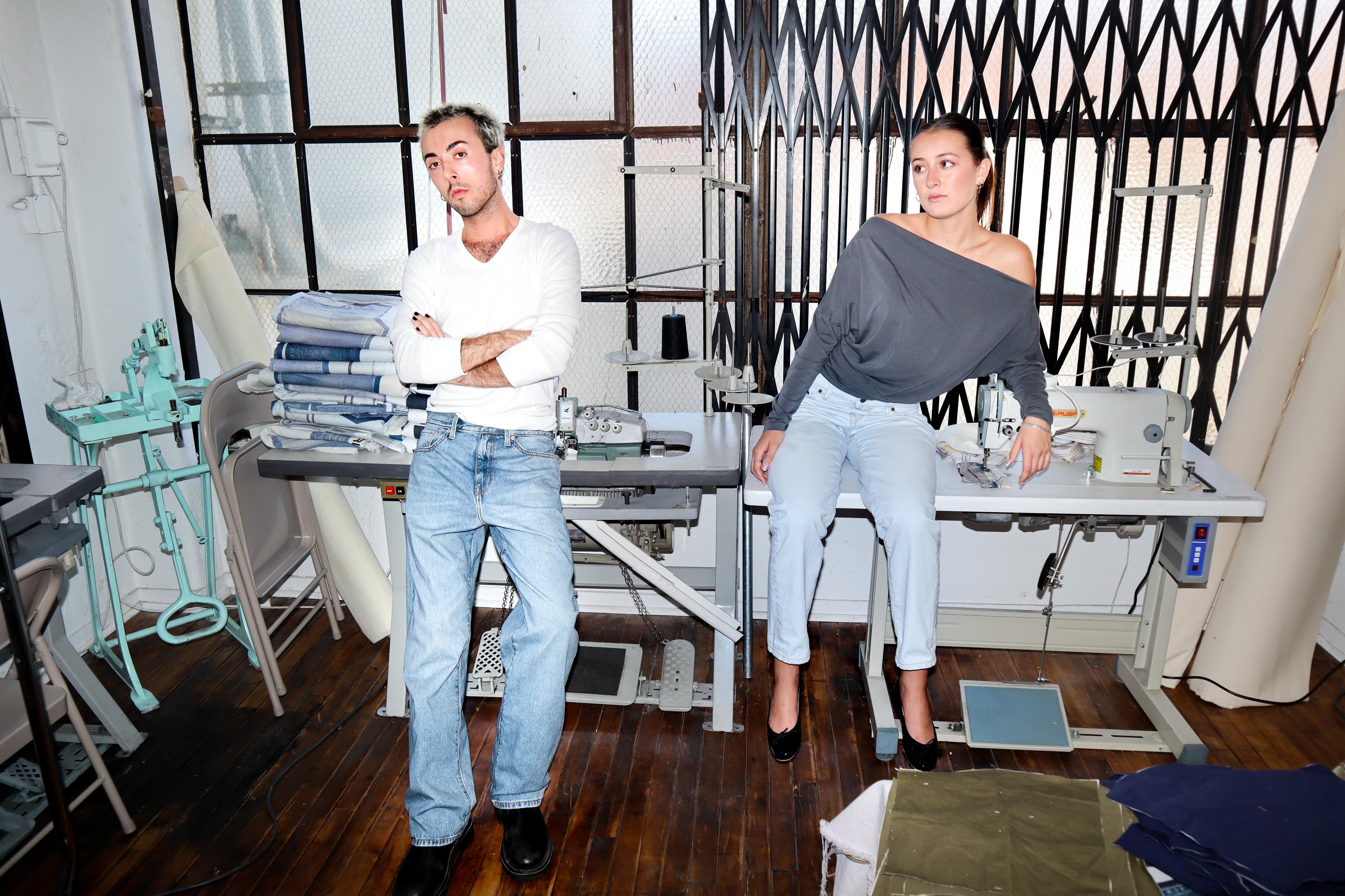 Male and female models in design studio with denim.