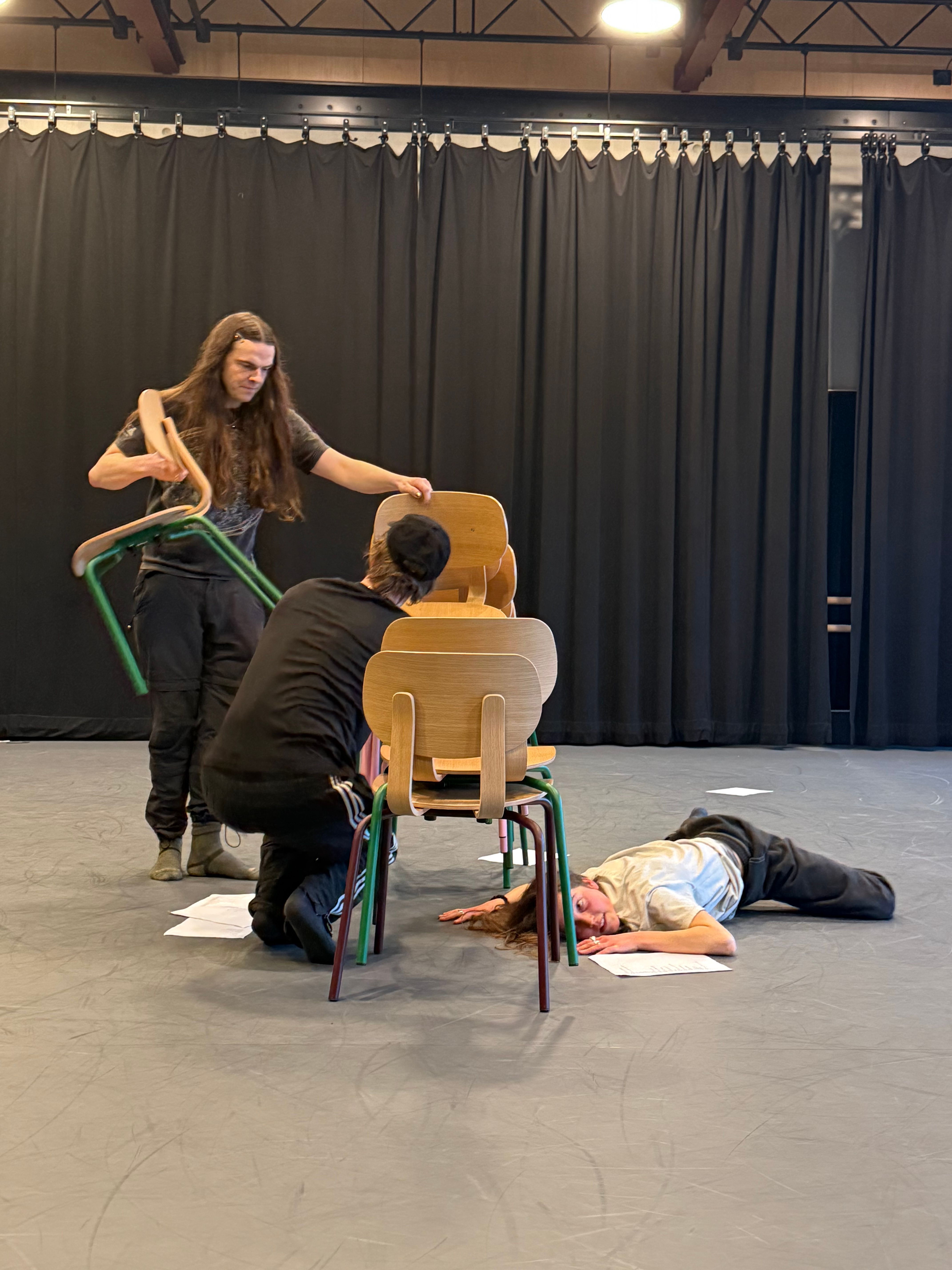 People stood on the ground with chairs