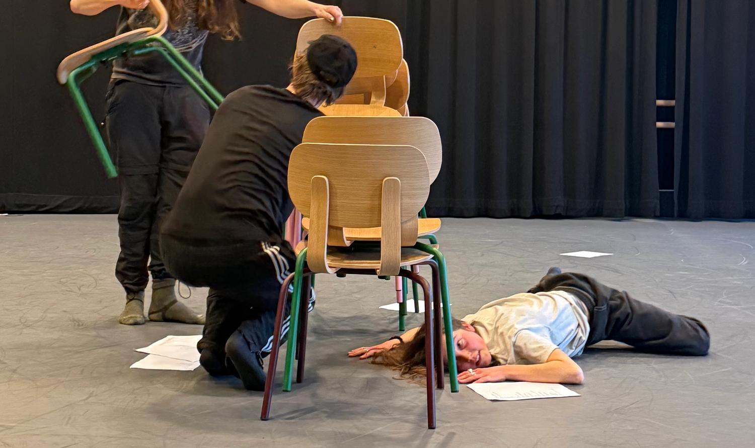 People stood on the ground with chairs
