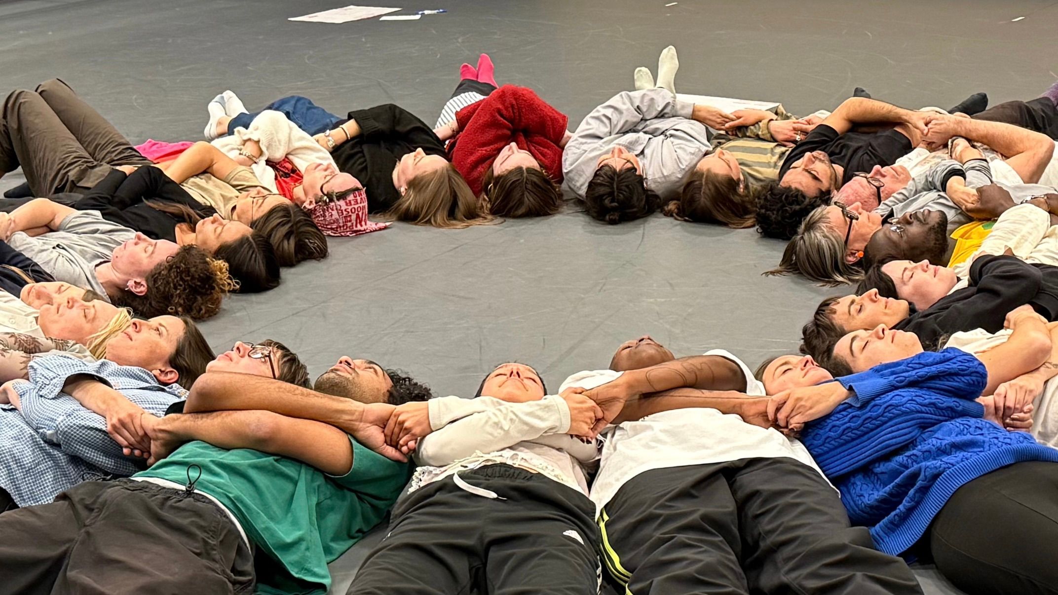 lying in a circle, shoulder to shoulder