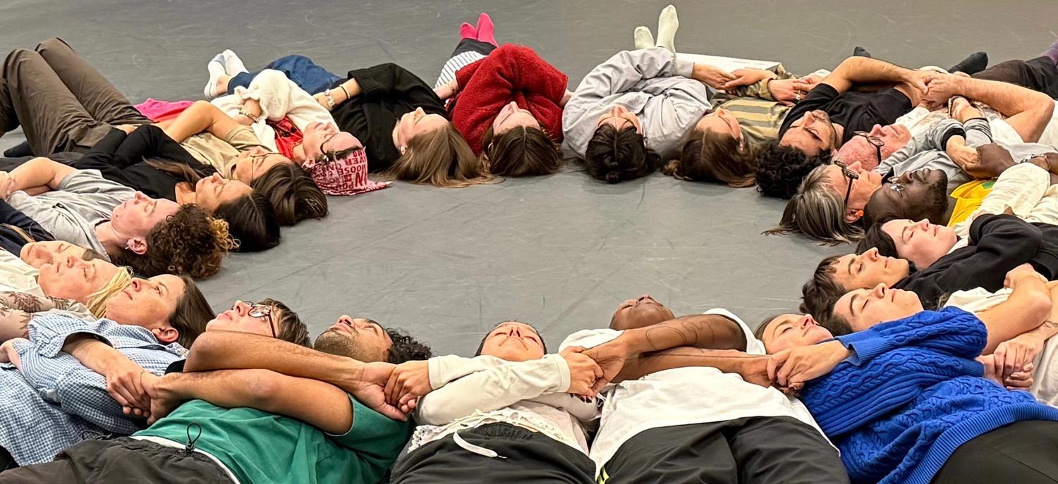 lying in a circle, shoulder to shoulder