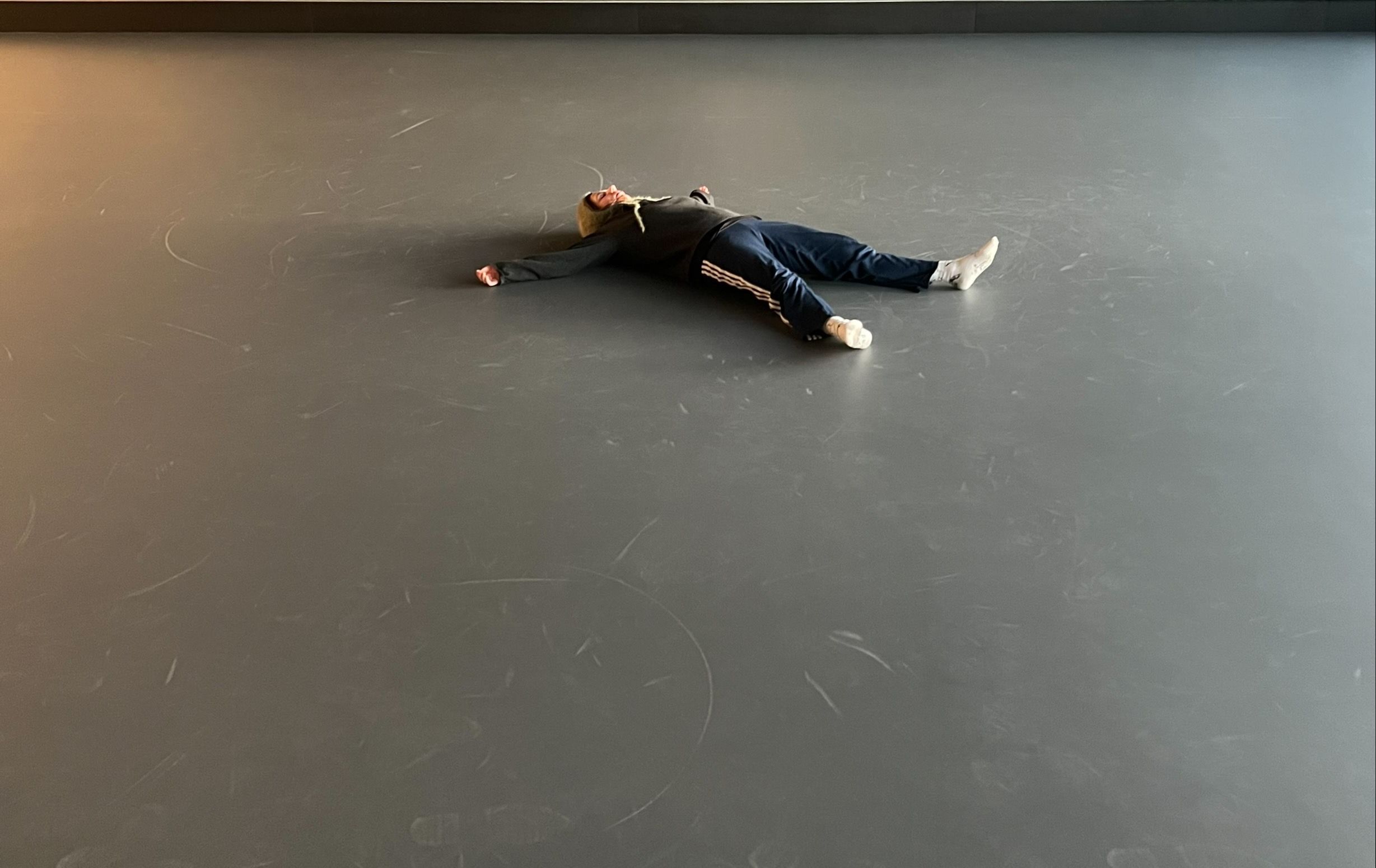 Lorea lying on the studio floor.