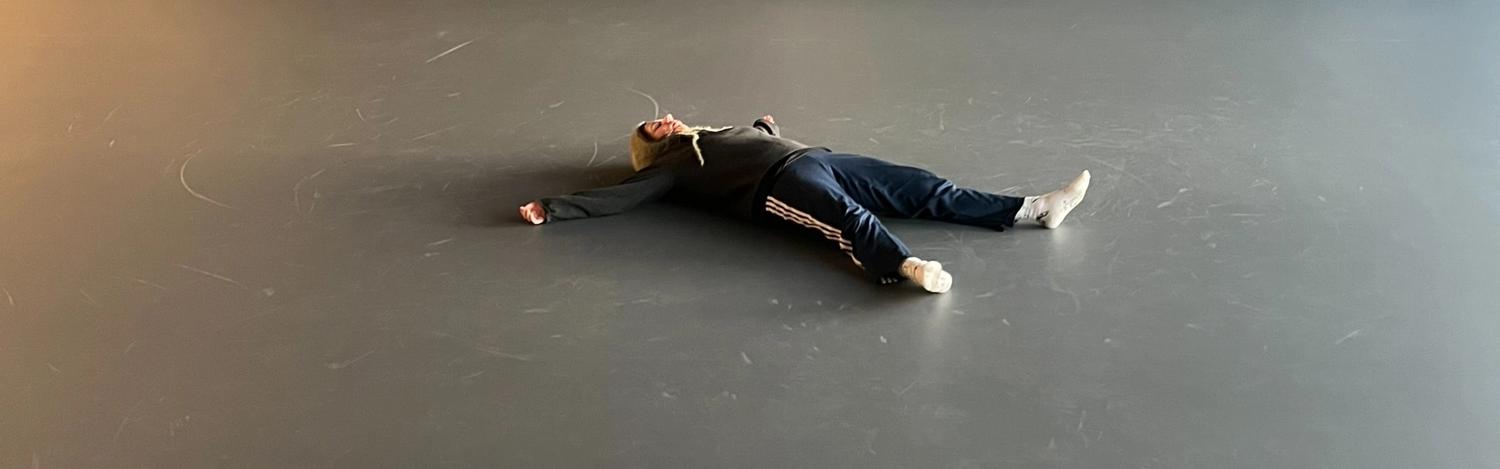 Lorea lying on the studio floor.