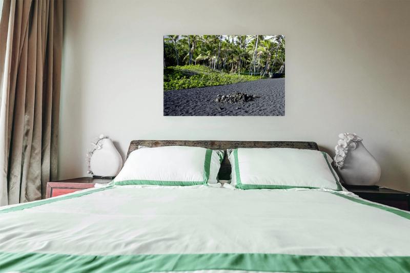 Print hanging on wall with bed