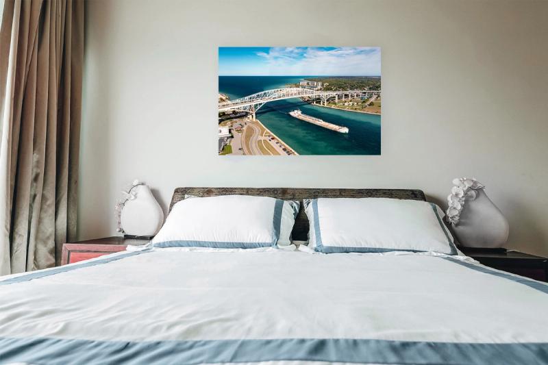 Print hanging on wall with bed