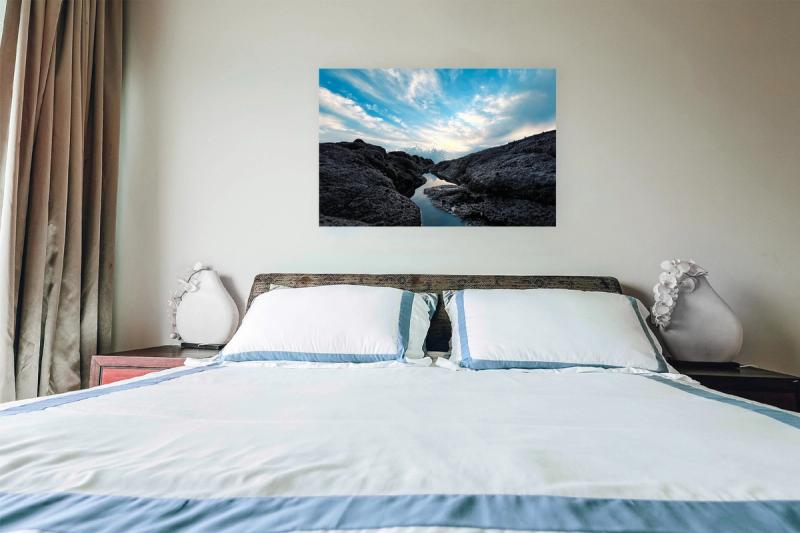 Print hanging on wall with bed