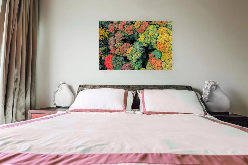 Print hanging on wall with bed