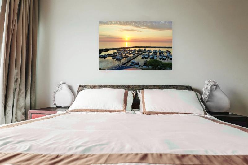 Print hanging on wall with bed