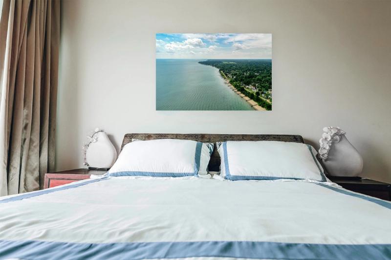 Print hanging on wall with bed