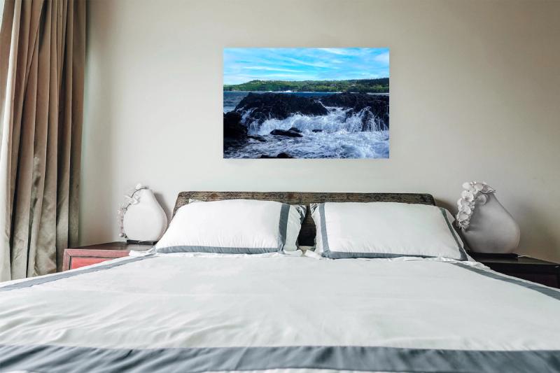 Prints hanging on wall with bed