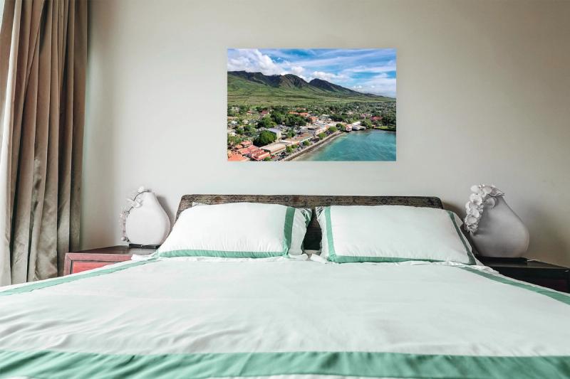 Print hanging on wall with bed