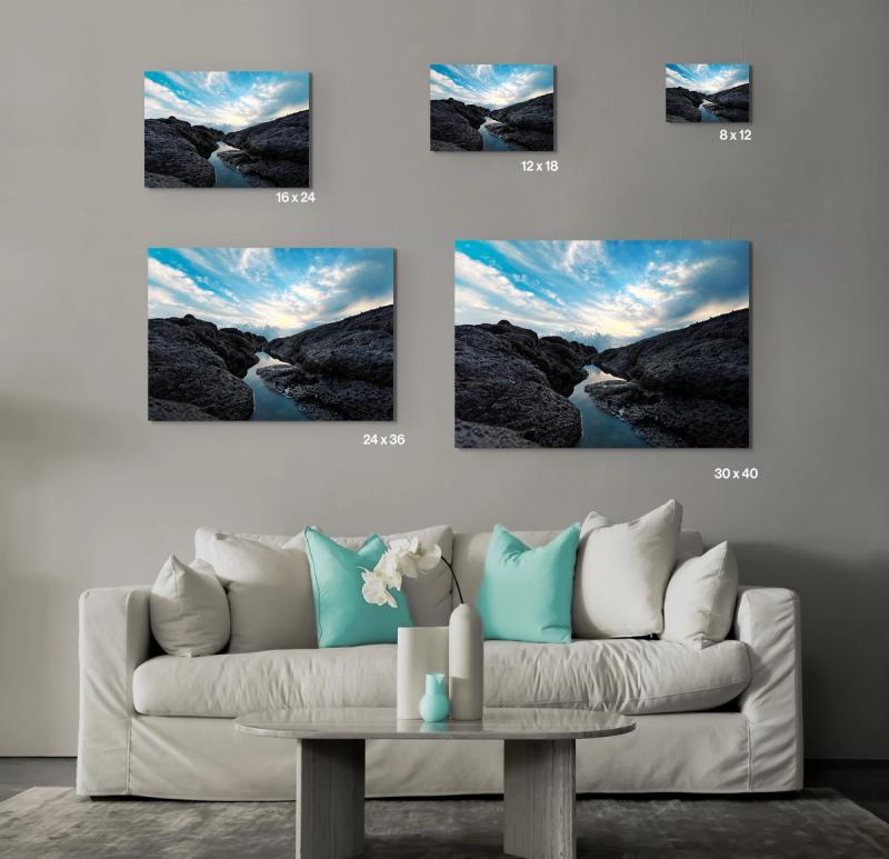 Prints hanging on wall with couch