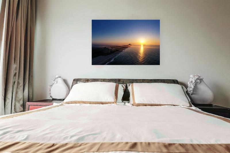 Print hanging on wall with bed