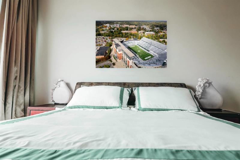 Print hanging on wall with bed