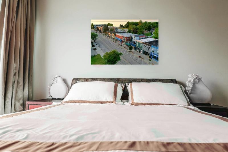 Print hanging on wall with bed