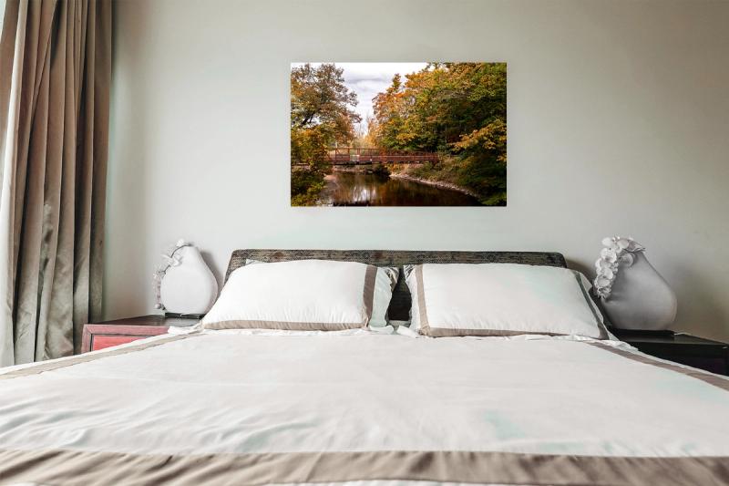 Print hanging on wall with bed