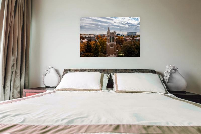 metal print hanging above bed