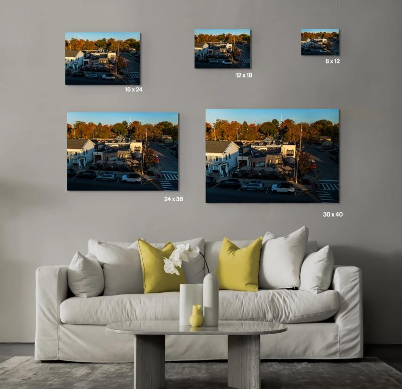 Prints hanging on wall with couch