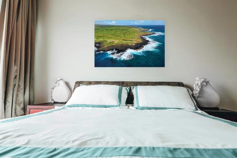 Print hanging on wall with bed