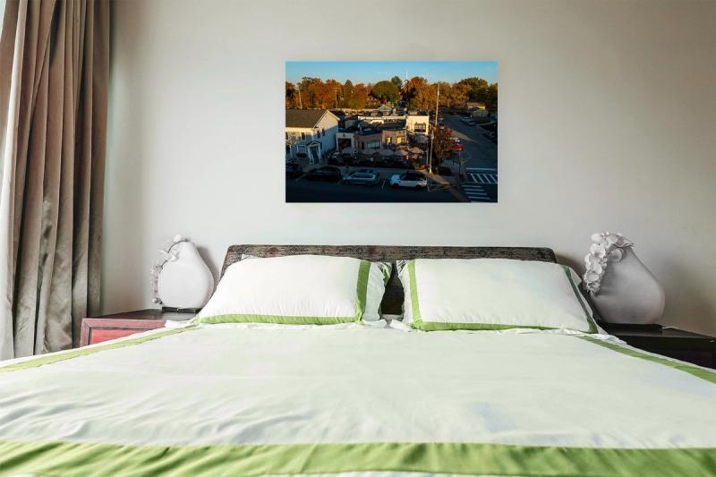 Print hanging on wall with bed