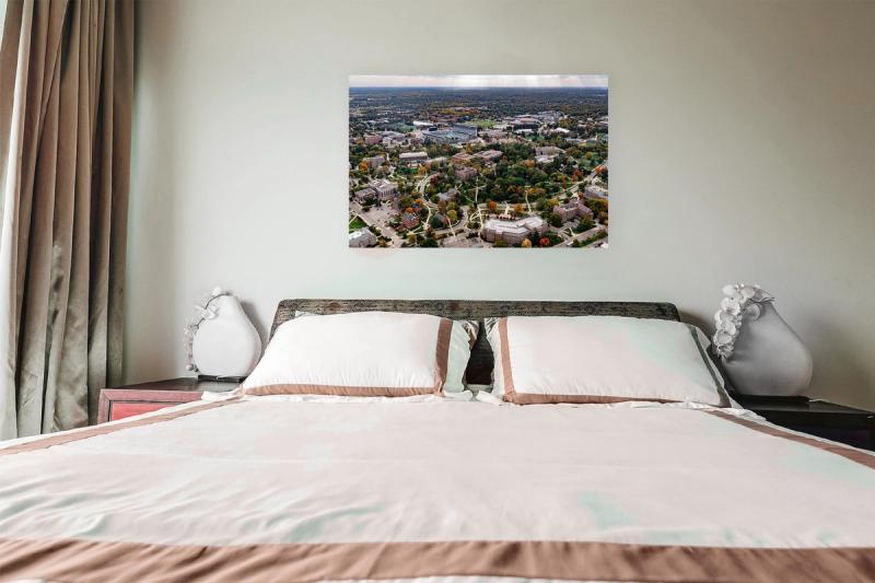 Print hanging on wall with bed