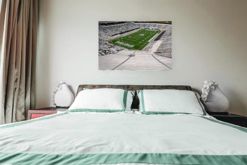 Print hanging on wall with bed