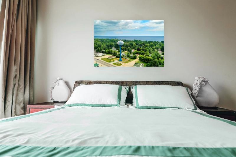 Print hanging on wall with bed