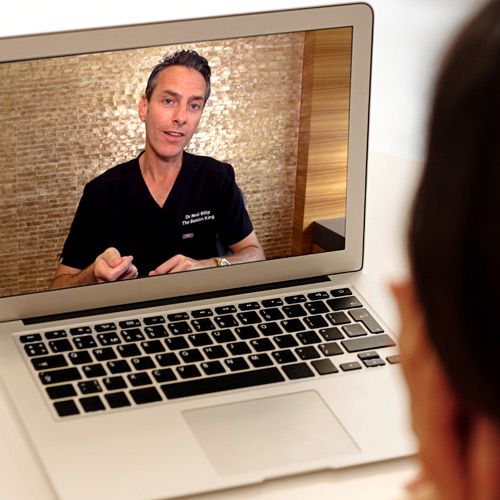 A doctor viewing an educational webinar led by Dr. Neal Blitz