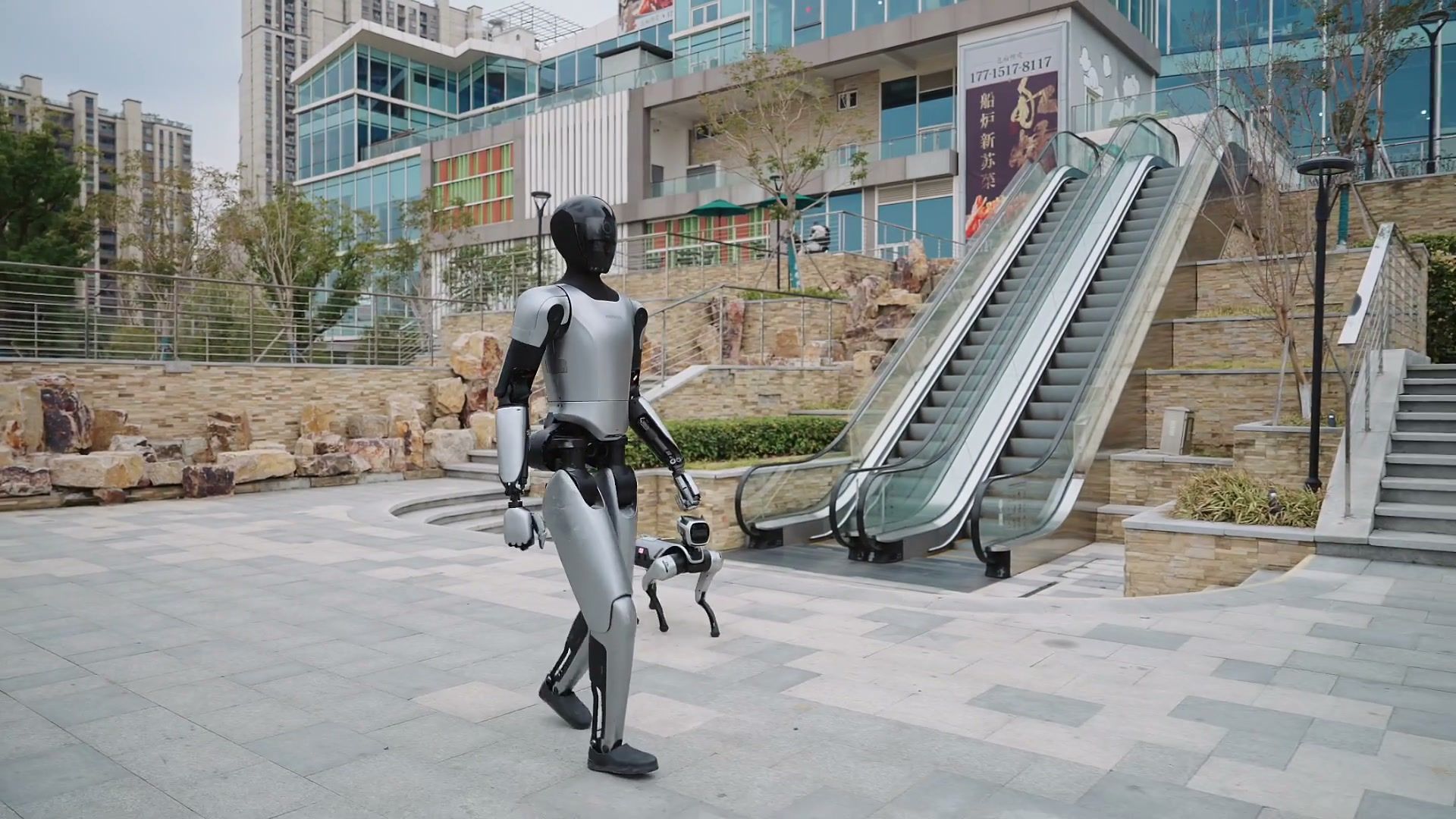 MagicBot humanoid robot walking through an urban plaza