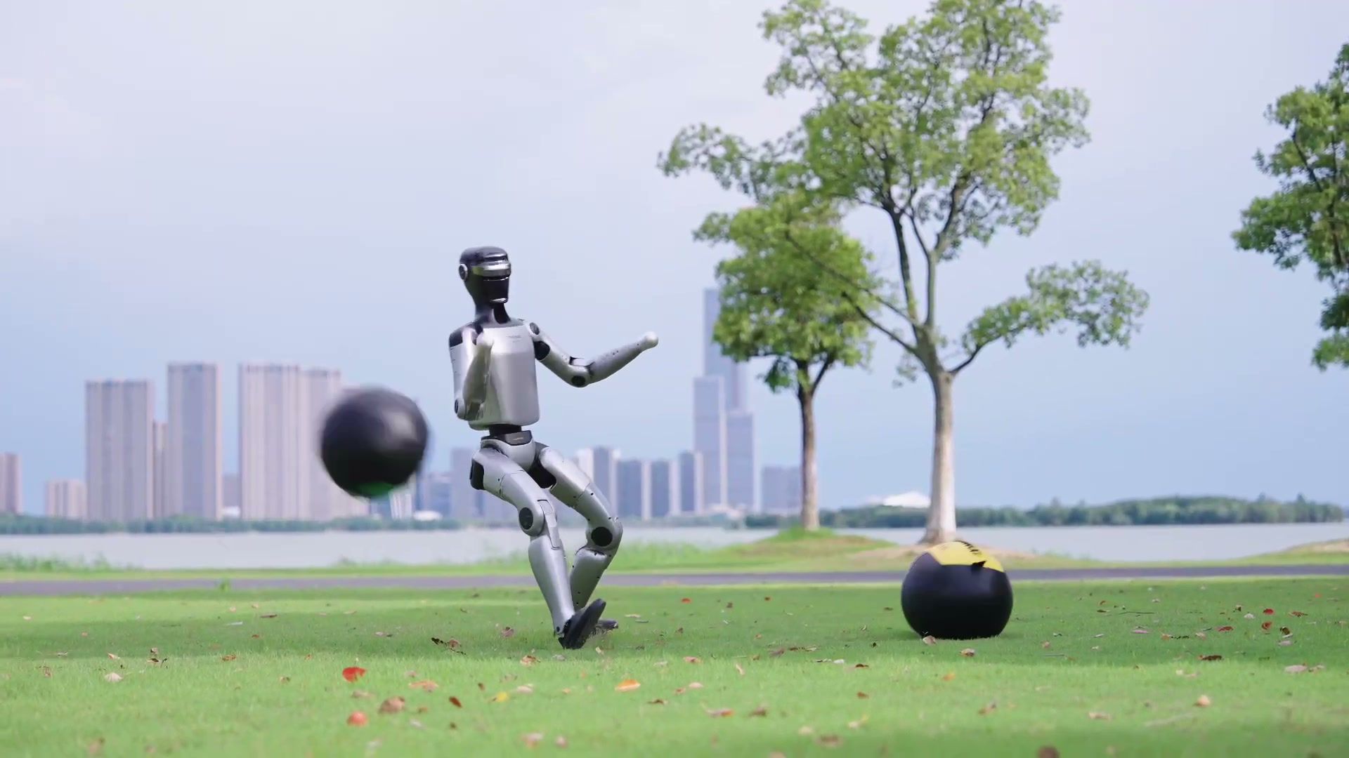 MagicBot Z1 humanoid robot striking a ball on grass
