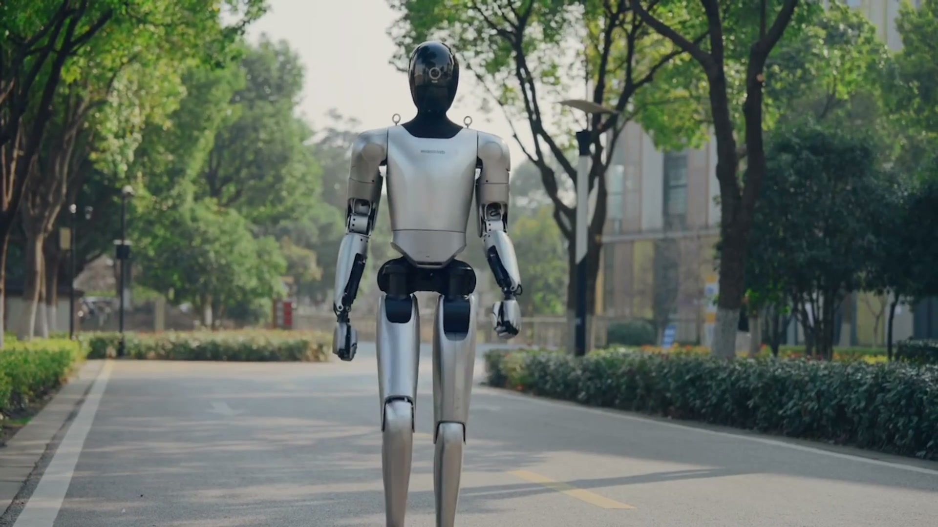 MagicBot humanoid robots walking along a tree-lined street