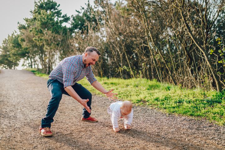 Happy Daddy with the baby crawling