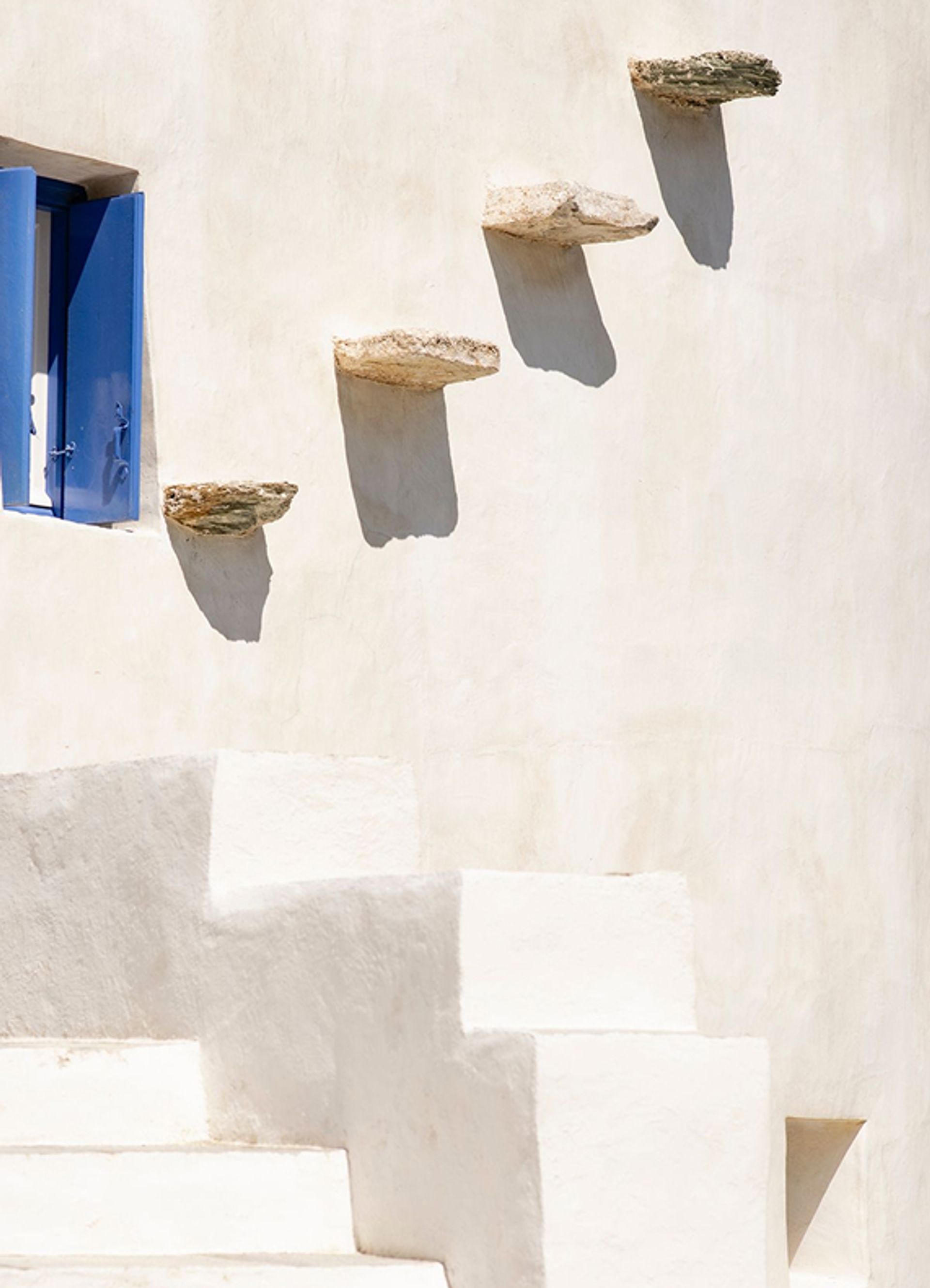 Stone steps leading up a whitewashed Ibiza facade