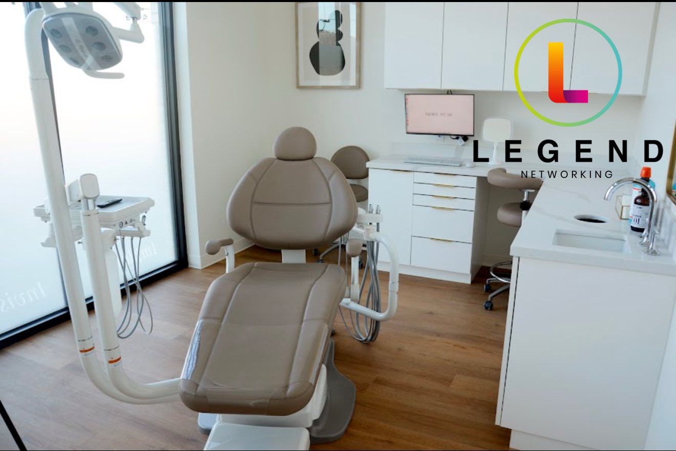 Treatment room with dental chair, cabinetry and monitor beside a window at MDRN MUSE Dental Aesthetics, Chattanooga, TN