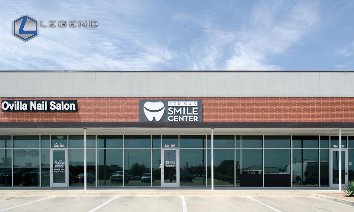 Storefront with the Red Oak Smile Center sign in a shopping center in Red Oak, TX