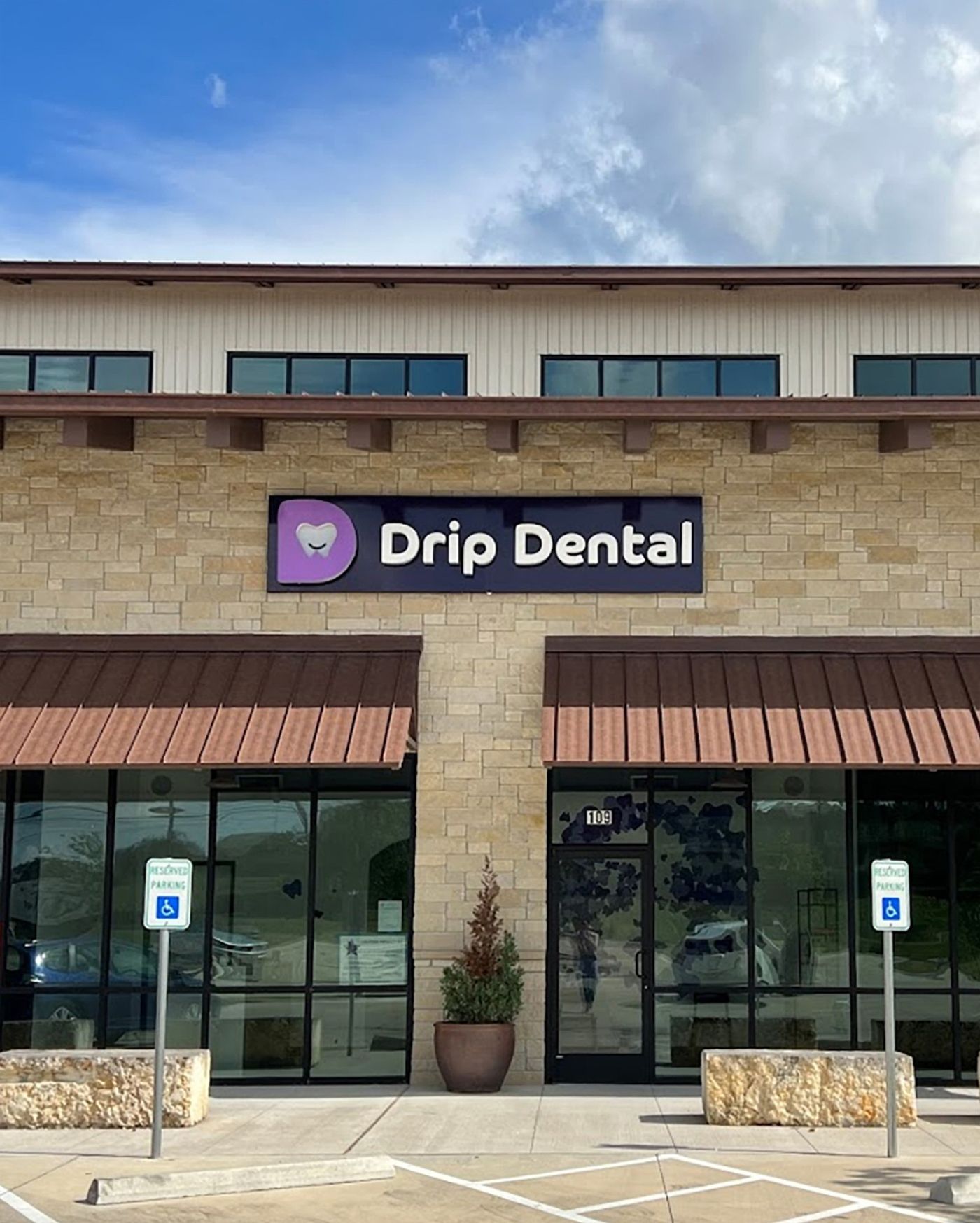 Storefront with the Drip Dental sign above the entrance in Dripping Springs, TX
