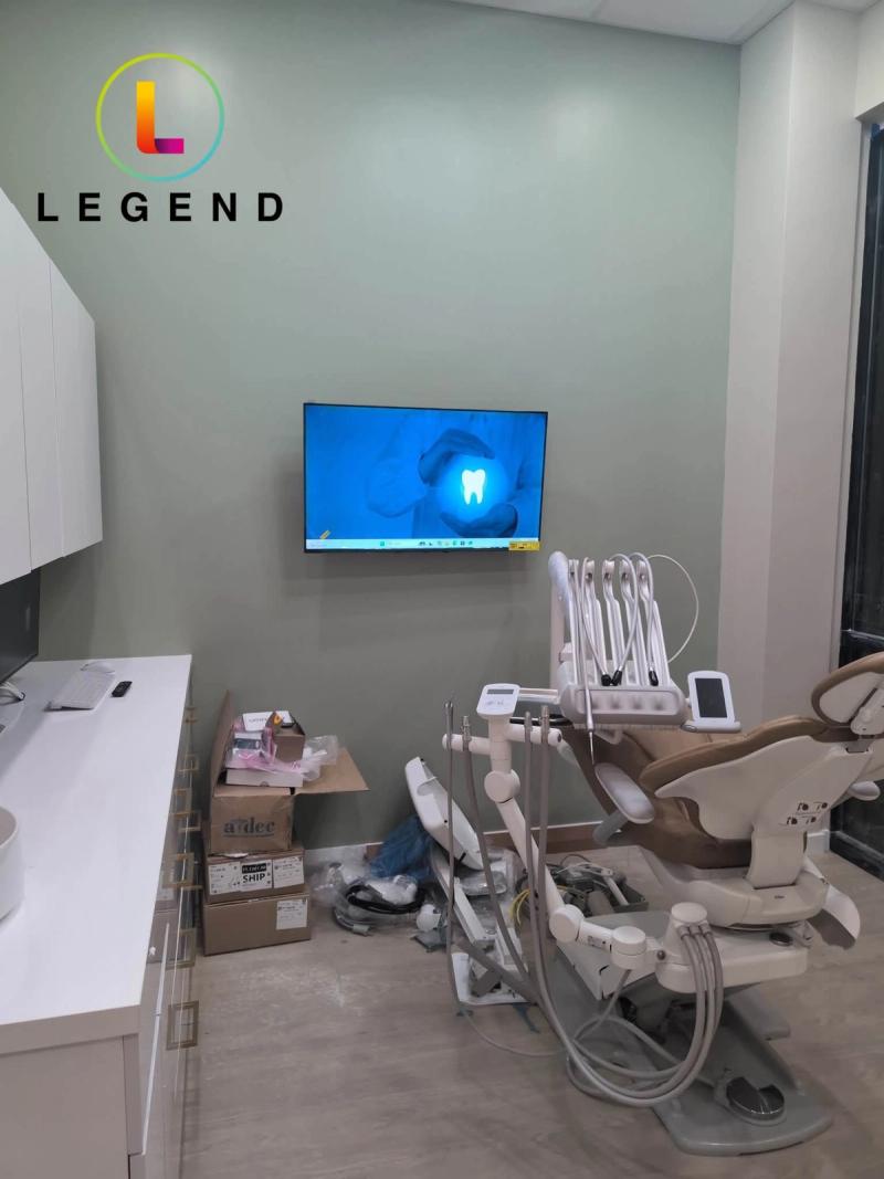 Treatment room with dental chair and wall-mounted screen at Harmony Dental and Facial Aesthetics, Wesley Chapel, FL