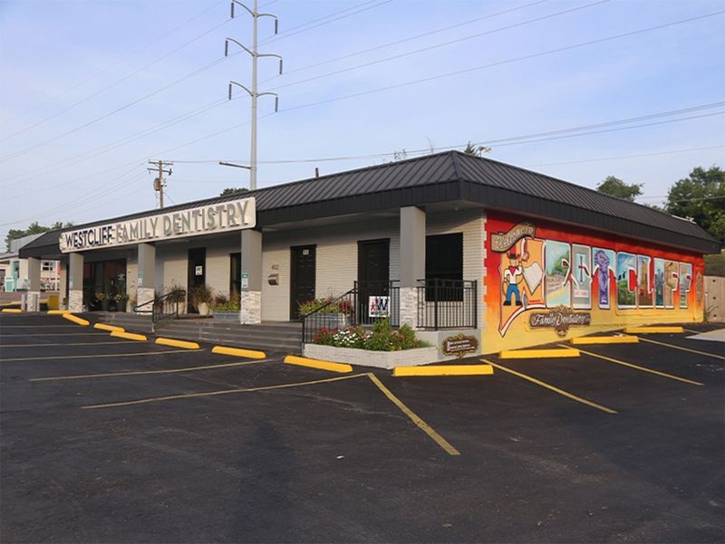 Building exterior with Westcliff Family Dentistry sign and painted welcome mural in Fort Worth, TX