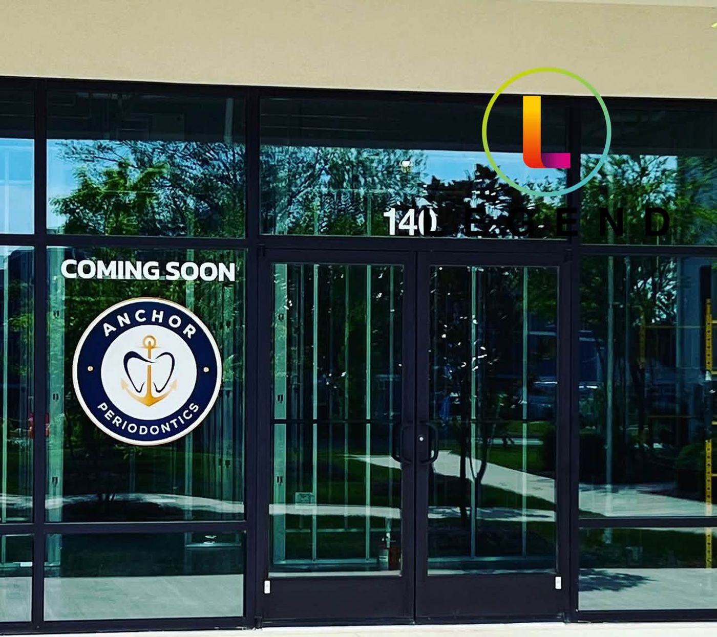 Glass entrance with Coming Soon decal and Anchor Periodontics logo in Stevensville, MD