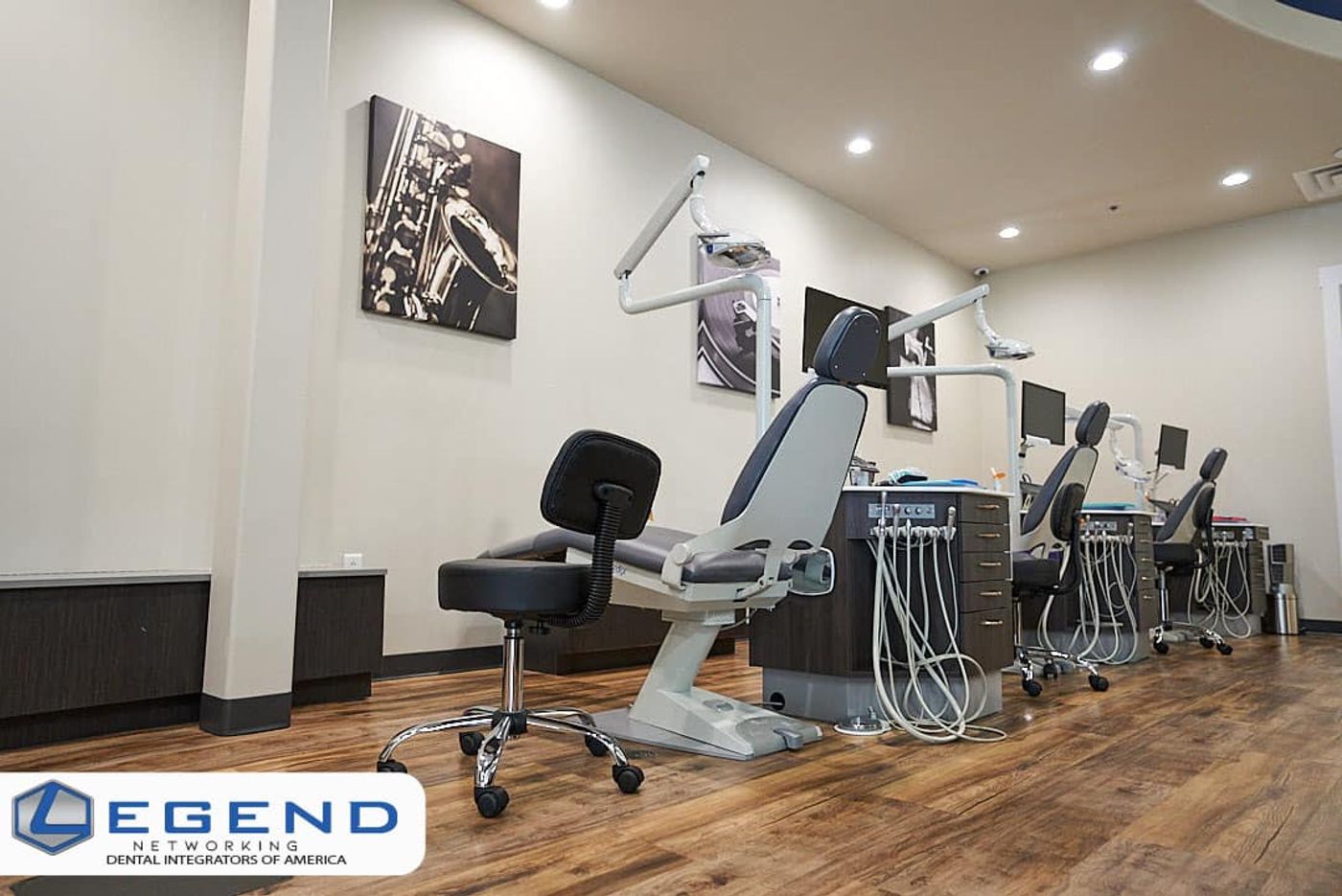 Open-bay row of orthodontic chairs with delivery units and wall art at Next Level Orthodontics, New Braunfels, TX